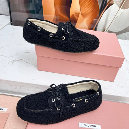 MIUMIU 26S BOAT LOAFERS IN BLACK SHEARLING