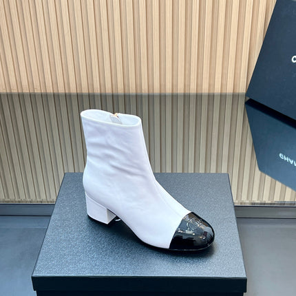 CHANEL 25S BOOTS WITH PATENT TOE CAP 50MM IN WHITE AND BLACK CALFSKIN