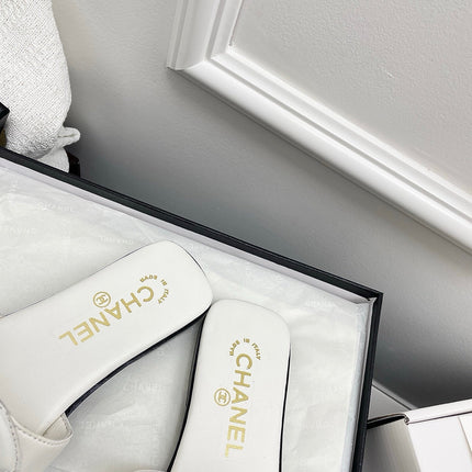 CHANEL CC LOGO MULES IN WHITE CALFSKIN