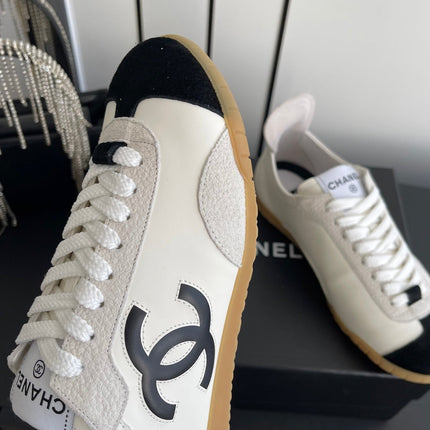 CHANEL LOW-TOP SNEAKERS IN BLACK AND WHITE CALFSKIN MIX SUEDE