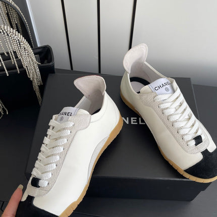 CHANEL LOW-TOP SNEAKERS IN BLACK AND WHITE CALFSKIN MIX SUEDE