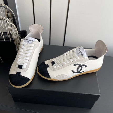 CHANEL LOW-TOP SNEAKERS IN BLACK AND WHITE CALFSKIN MIX SUEDE